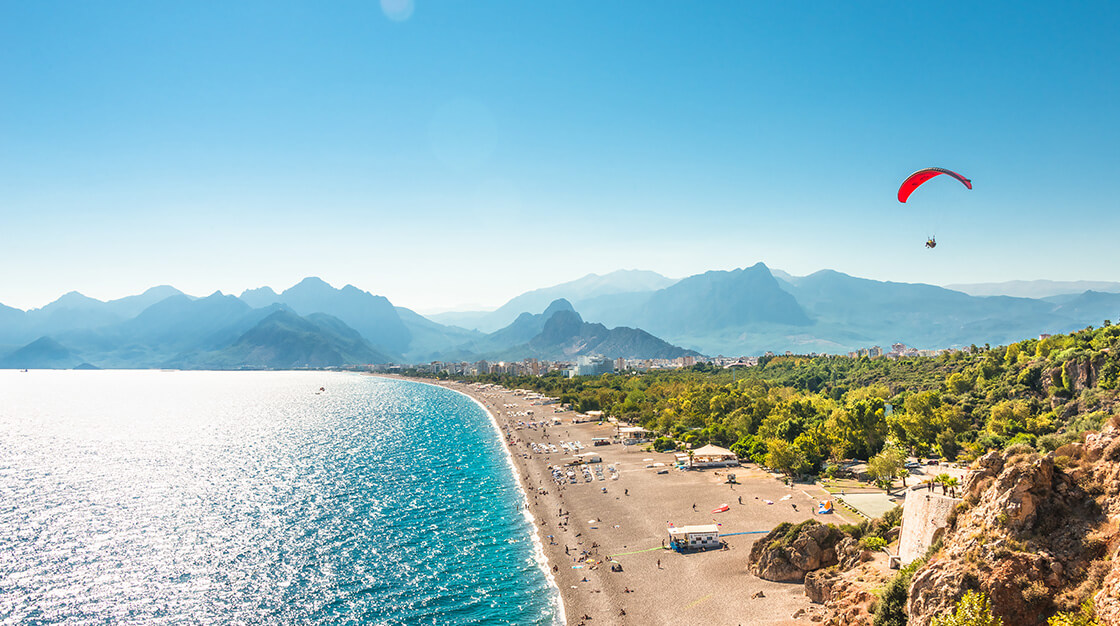 Panoramablick auf Antalya und Mittelmeerküste und Strand mit Einem Gleitschirm, Antalya, Türkei